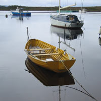 Fishing boats reflecting in the bay at Strahan, on the west coast of Tasmania