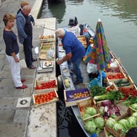 Floating fruit market boat on a canal in Venice